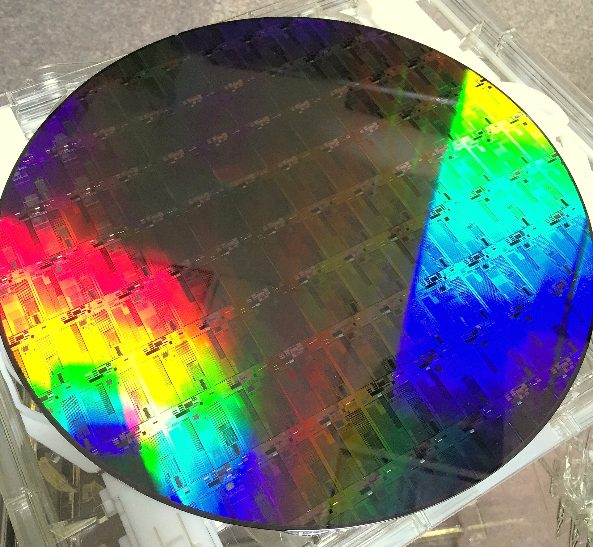 A 300mm silicon wafer patterned with silicon photonics chips, the wafer size the new New York fabs will use